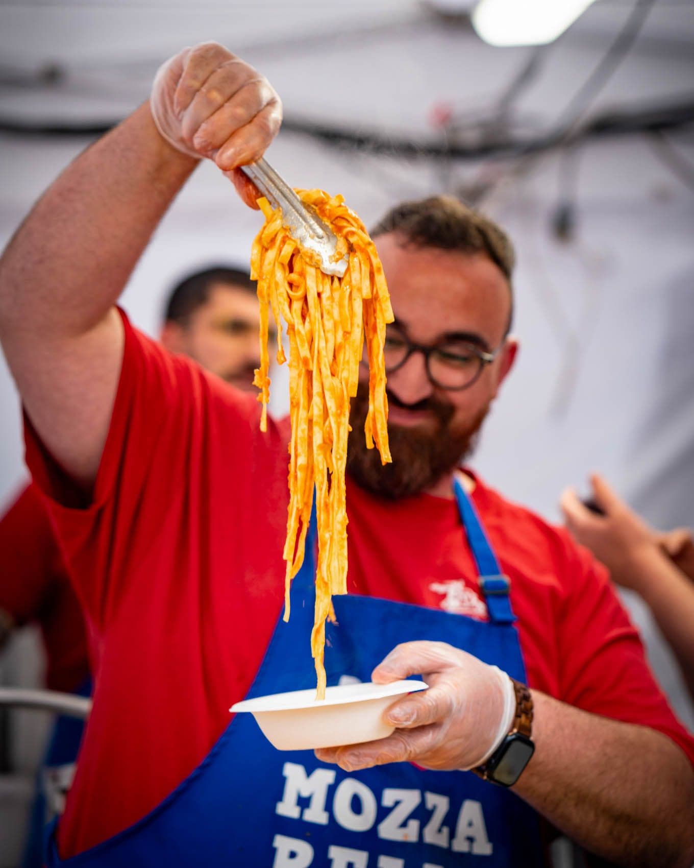 Chef lifting fresh pasta on a fork