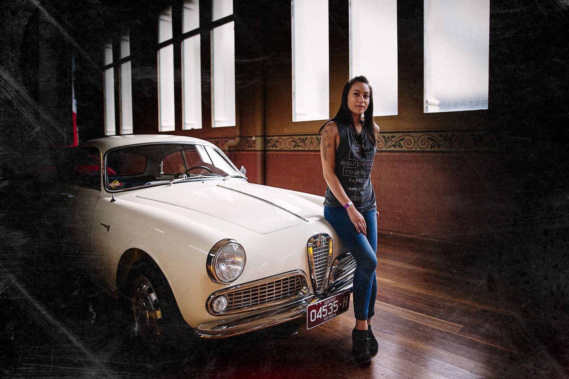A classic white car inside the Royal Exhibition Building