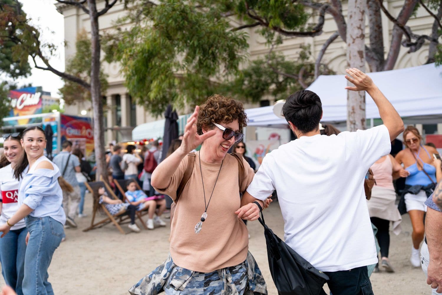 Crowd chatting and drinking at an outdoor festival