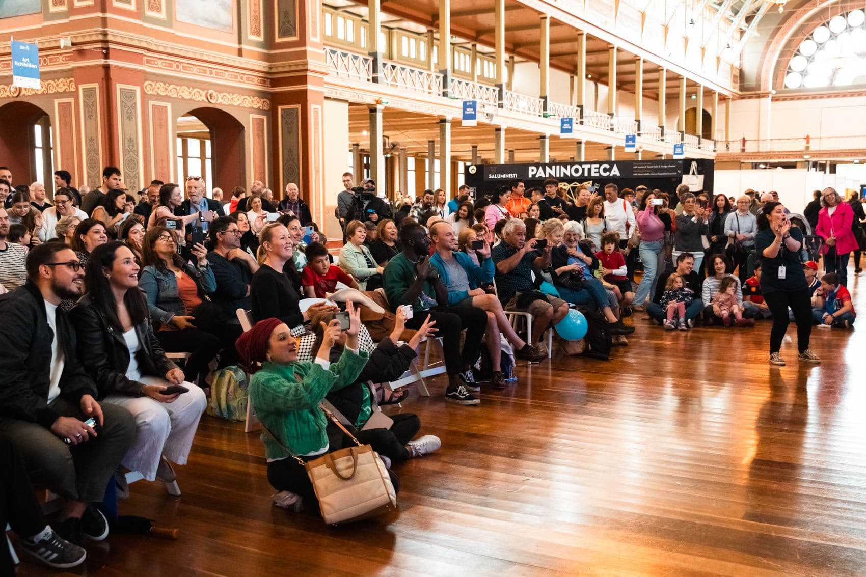 Interior of the Royal Exhibition Building filled with people exploring an exhibition