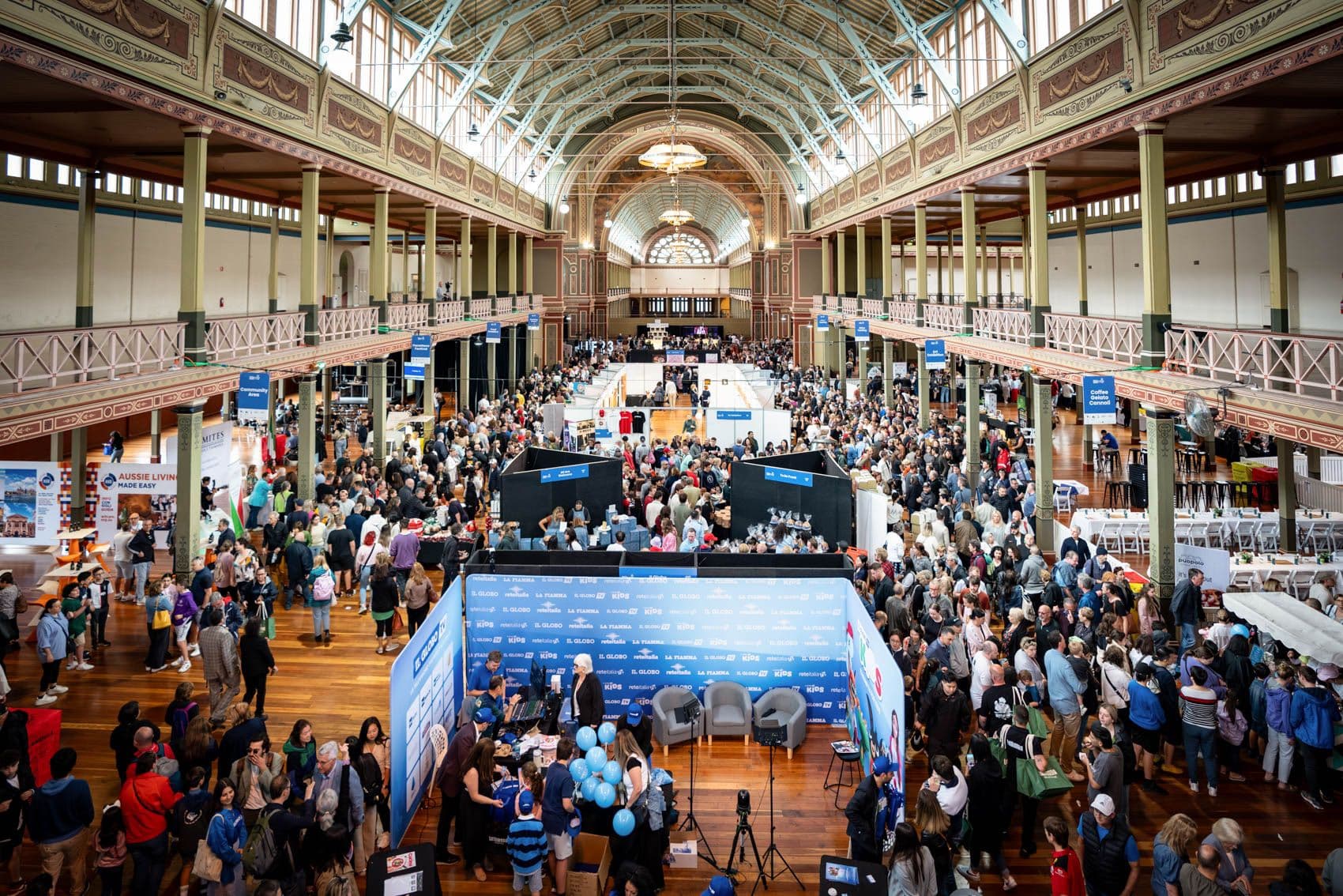 Crowded festival floor in an ornate heritage hall